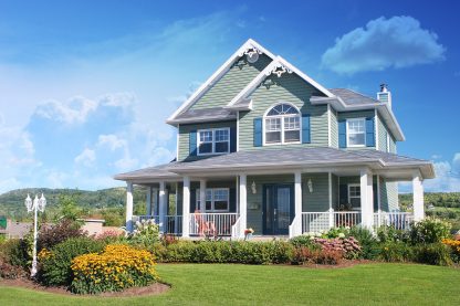 Cozy Modern Pastel Cottage House with Outdoor Flower Arrangement Stock Image